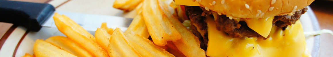 Eating Burger Food Stand at Rosa's Hamburger Stand restaurant in Dilley, TX.